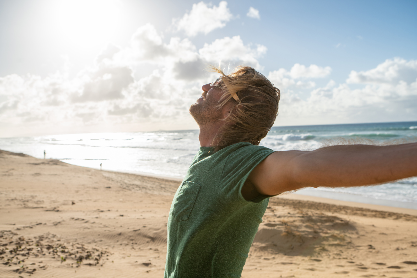 Happy man on beach at sunset